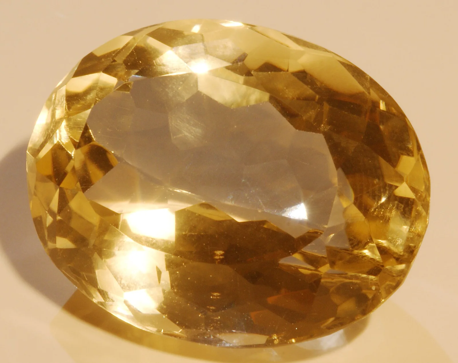 Conceptual image of a faceted transparent yellow citrine gemstone.