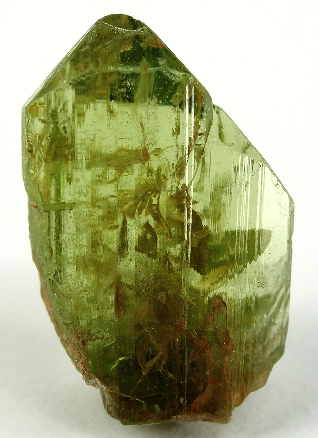 Transparent greenish-yellow peridot crystal with visible crystal structures.